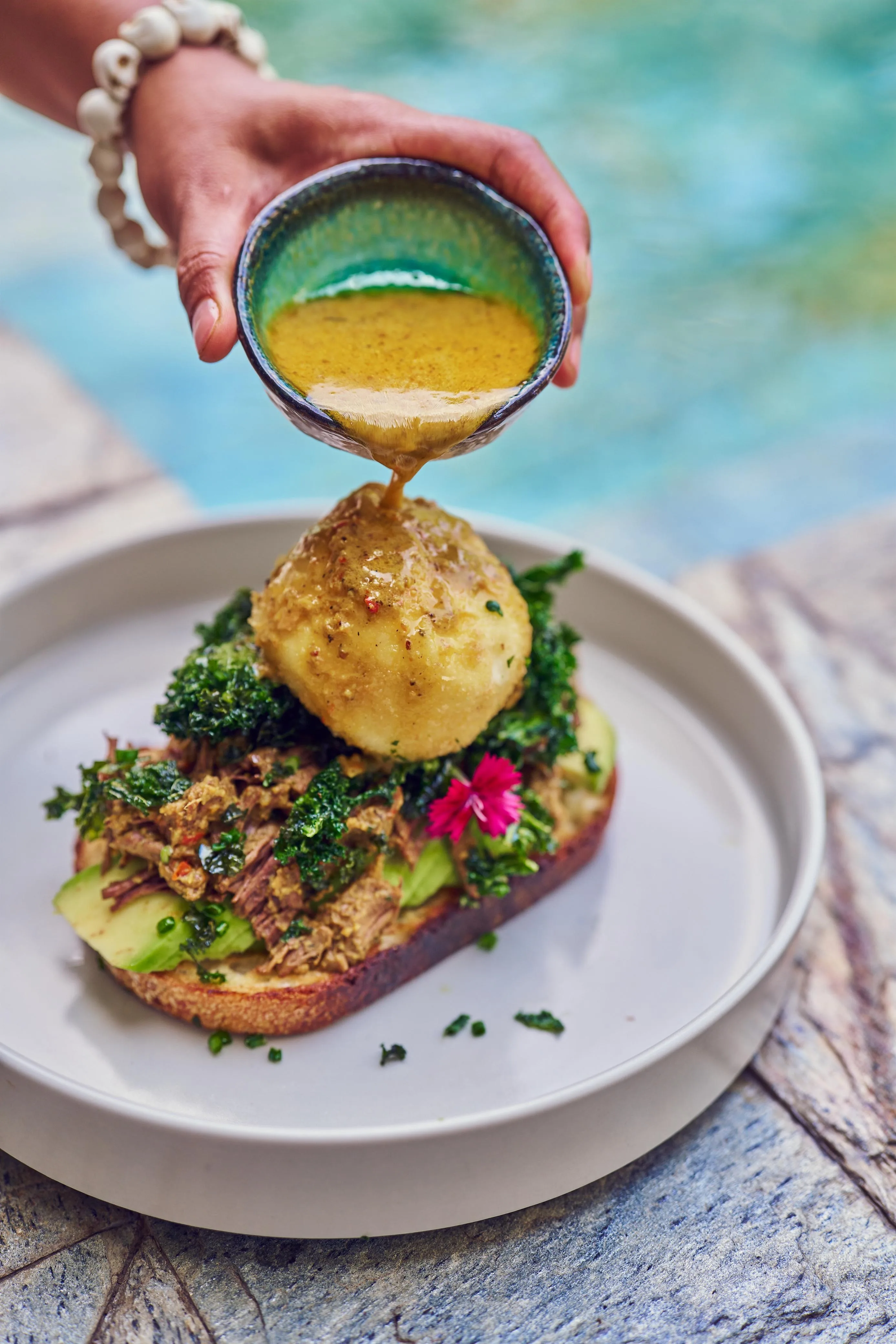 Avocado sourdough with pulled meat and broth pour