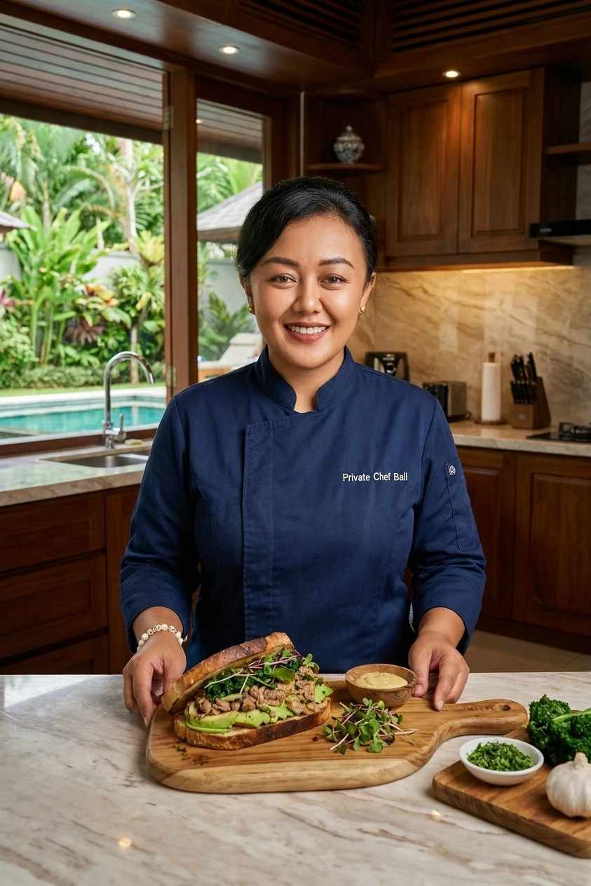Banda in a villa kitchen, plating an open-face sandwich